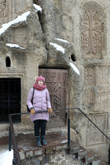 Woman on background of Geghard Monastery