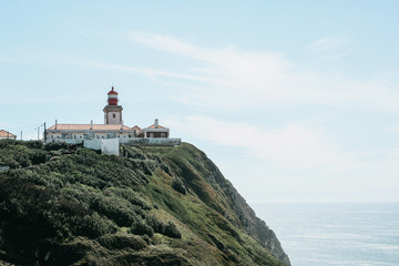 Fototapeta na wymiar Beautiful view of the lighthouse and the natural landscape at Cape Roca in Portugal on a sunny day
