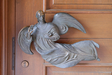 Angel on the door of the Saint Lawrence church in Kleinostheim, Germany