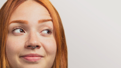 portrait of a pretty redhead girl looking at side