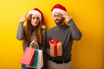 Couple or friends holding gifts and shopping bags doing a suicide gesture