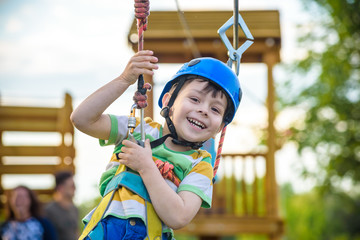 Young boy playing and having fun doing activities outdoors. Happiness and happy childhood concept © pahis