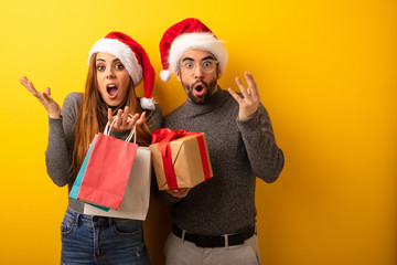 Couple or friends holding gifts and shopping bags celebrating a victory or success