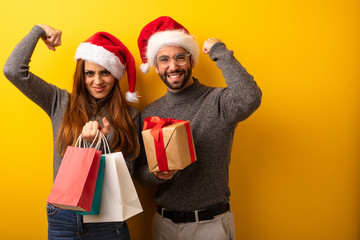 Couple or friends holding gifts and shopping bags who does not surrender