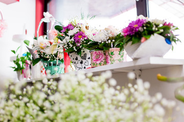 Beautiful floral decoration in flower shop by the window