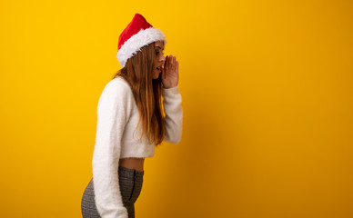 Young pretty woman holding gift whispering gossip undertone