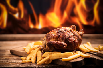 Grilled chicken with fire grill background