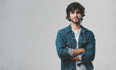 Obraz premium Young handsome man crossing his arms, smiling and happy, being confident and friendly
