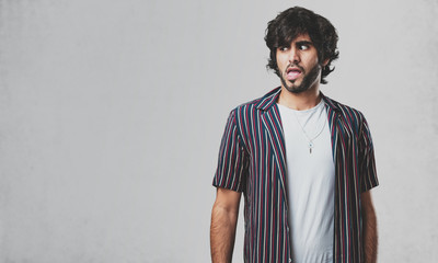 Young handsome man very scared and afraid, desperate for something, cries of suffering and open eyes, concept of madness