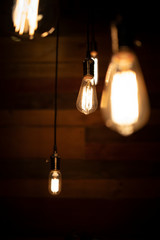 Close up many yellow lamp in cafe at night