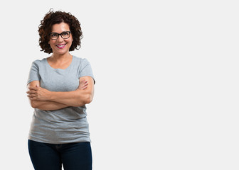 Middle aged woman crossing his arms, smiling and happy, being confident and friendly