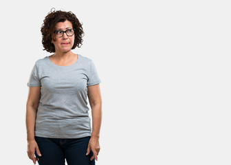 Fototapeta premium Middle aged woman doubting and confused, thinking of an idea or worried about something