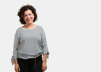 Middle aged woman cheerful and with a big smile, confident, friendly and sincere, expressing...