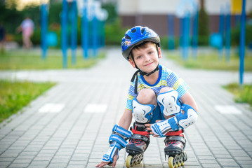 Smiling boy with inline skates and protective gear