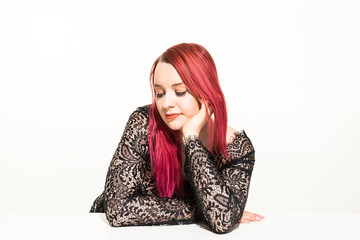 Beautiful woman with red long hair wearing a lacy dress. Beauty portrait of modern fashion, white...