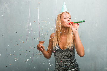 Portrait of young elegant blonde woman celebrating a party.