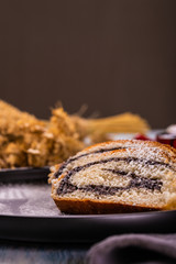 Poppy seed strudel on dark plate with silhouette of fork made by sugar