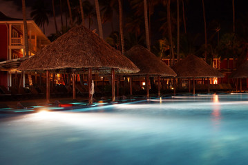 Tropical resort pool at night