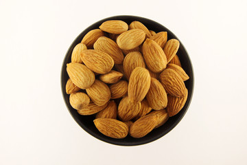 Almonds in black bowl.