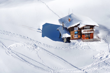 Chalet covered with snow in the Transylvanian Alps, Romania, Europe