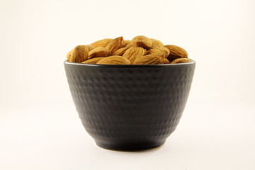 Almonds in black bowl.