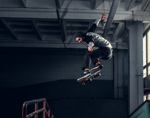 Skateboarder jumping high on mini ramp at skate park indoor.