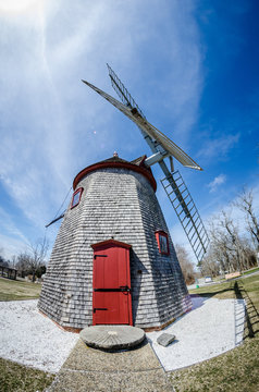 Eastham Windmill was built in 1680 and today, this historic old fashioned mill sits in a Cape Cod Park in Massachusetts. Fisheye lens view