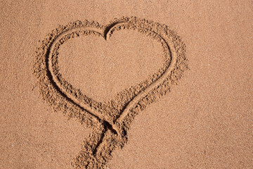Painted heart on the sand.