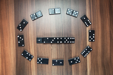 Game of domino on wooden background.