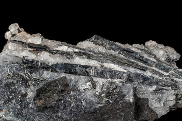 Macro mineral stone Stibnite quartz on a black background