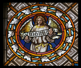 Symbols of the Saint Matthew the Evangelist, stained glass window in the parish church of St. Peter and Paul in Oberstaufen, Germany