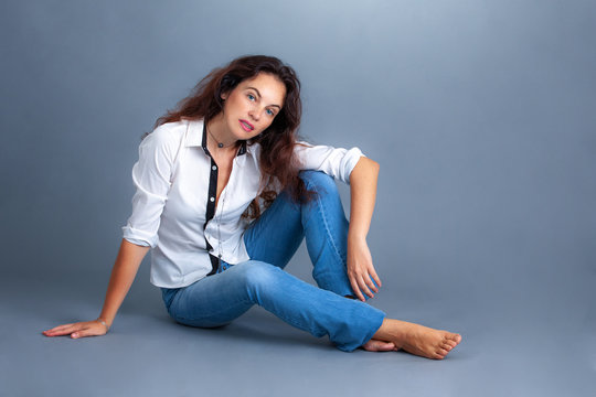Woman In Jeans And White Shirt In The Studio