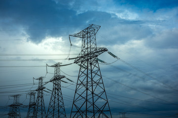  high-voltage  power lines at storm clouds.