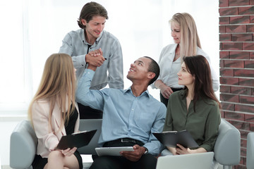 business woman and her business team discussing the data with a tablet computer