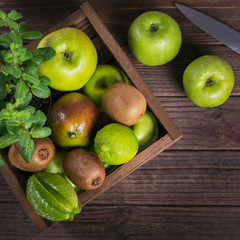 Set of green fruits for healthy diet and detox: apple, lime, kiwi, mango, carambola and mint.