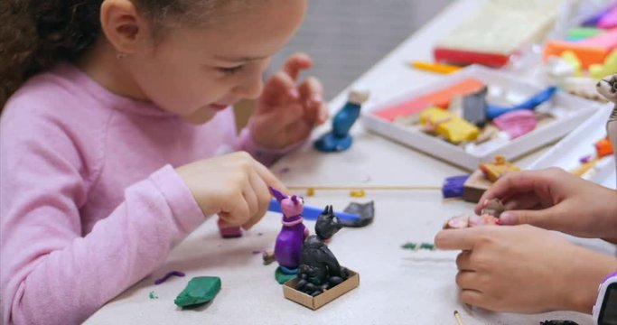 Cute Little Children Sitting at the Desk Sculpts a Different Figures From Made of Colored Modeling Plasticine in the Nursery. Development of the Art of Modeling in Children.