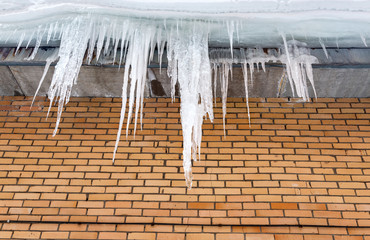 Transparent icicles on the roof of the house