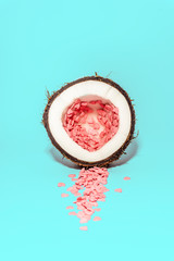 Love concept minimal. Bright colorful background with coconut and candy hearts in pink and turquoise colors. Valentine's day minimal concept. Contemporary art design, abstract minimalism