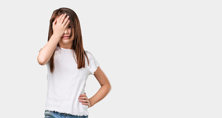 Full body little girl worried and overwhelmed, forgetful, realize something, expression of shock at having made a mistake