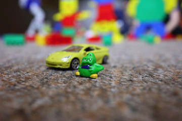 a small monster toy at a toy car, playroom for children