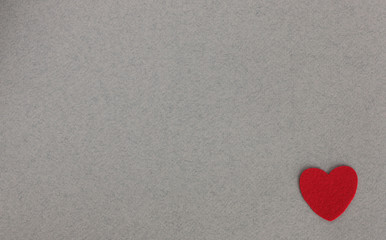 Obraz premium red felt hearts on grey background with place for inscription
