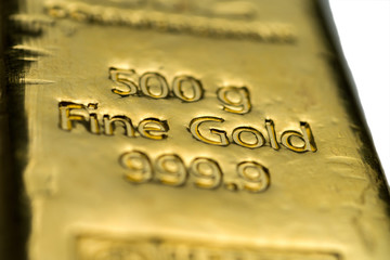The surface of cast gold bar weighing 500 grams. The texture of the surface of the gold bar. Selective focus. (shallow DOF)