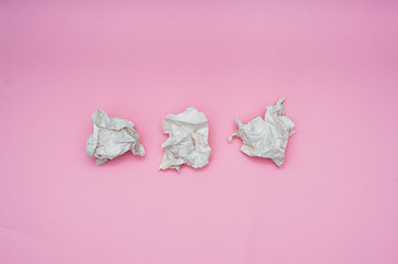 Lump crumpled paper on pink background. Eco friendly concept. Copy space. Flat lay.