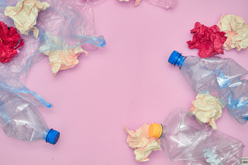 Plastic bags of used, paper and bottles on pink background. Eco friendly concept. Copy space. Flat lay.