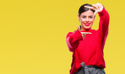 Young beautiful business woman wearing winter sweater over isolated background smiling making frame with hands and fingers with happy face. Creativity and photography concept.