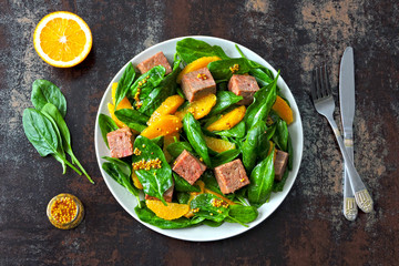 Healthy salad with spinach, orange and smoked salmon. Keto diet. Healthy eating concept. Salad good for body and skin.