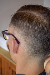 man with fresh haircutt  is posing satisfied
