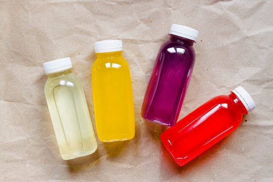 Plastic bottles with lemonade without label on a paper background
