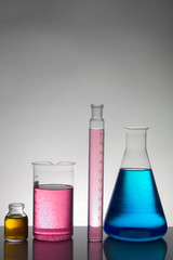 Liquid in laboratory bottles. Scientific biochemical laboratory. Colorful liquid.
