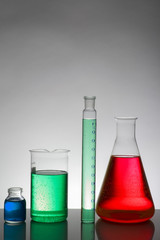 Liquid in laboratory bottles. Scientific biochemical laboratory. Colorful liquid.